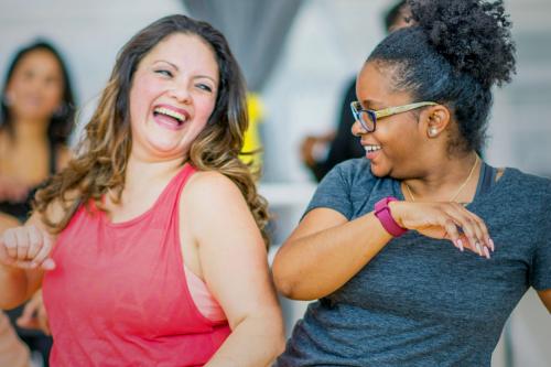 Two people smiling while dancing